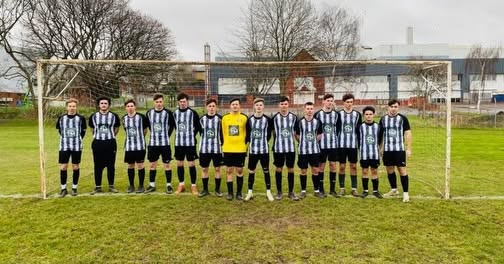 Imperial FC senior team lined up in front of goal before a match, wearing the TM Carpentry sponsored kit